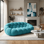 Canapé cocon double en tissu bleu turquoise, parfait pour un salon moderne et cosy.