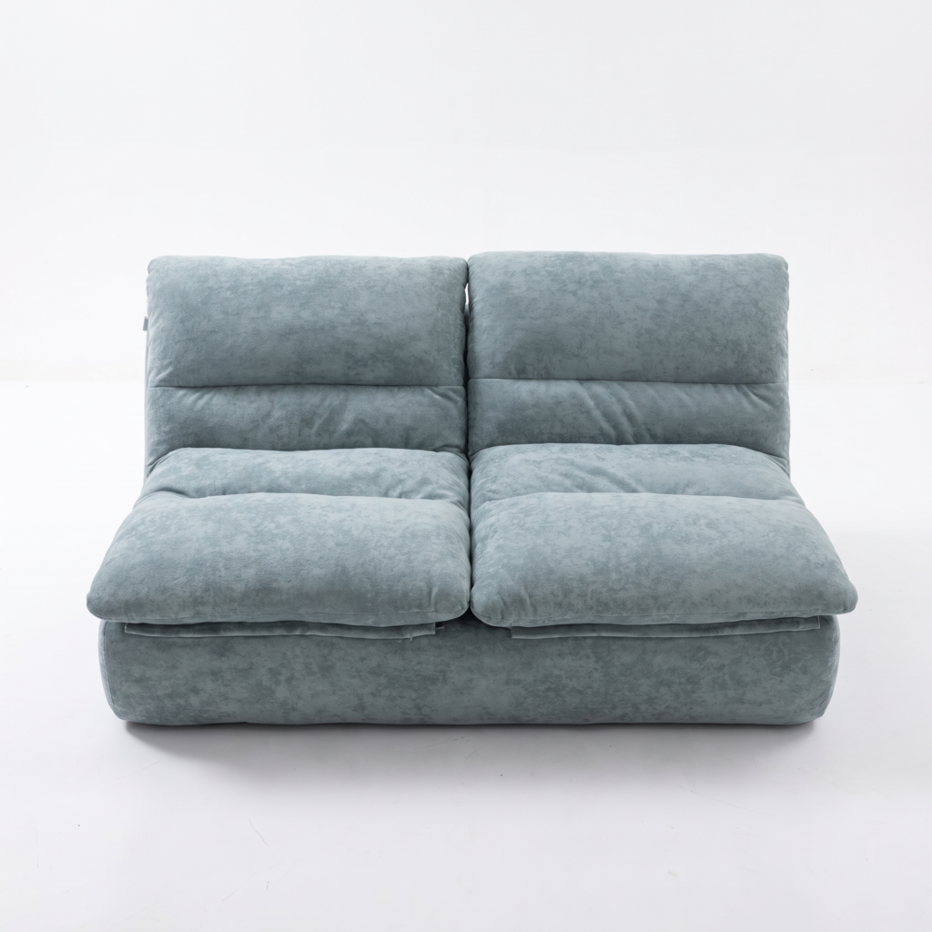 Canapé deux places modulable bleu-gris en velours avec assises et dossiers capitonnés épais, photographié sur fond blanc uni.